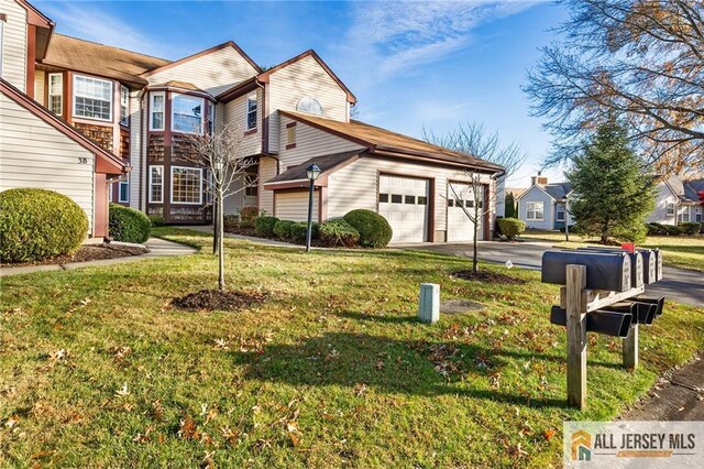 view of front of house featuring a garage and a front lawn