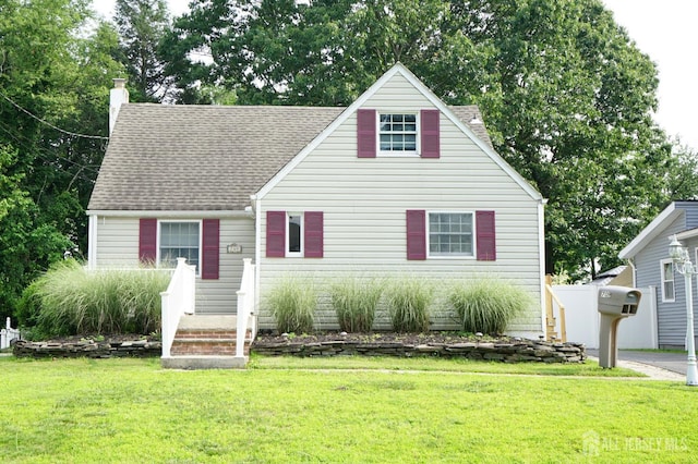 709 Wadsworth Ave, South Plainfield, NJ 07080 - new england style home featuring a chimney, a front yard, and a shingled roof