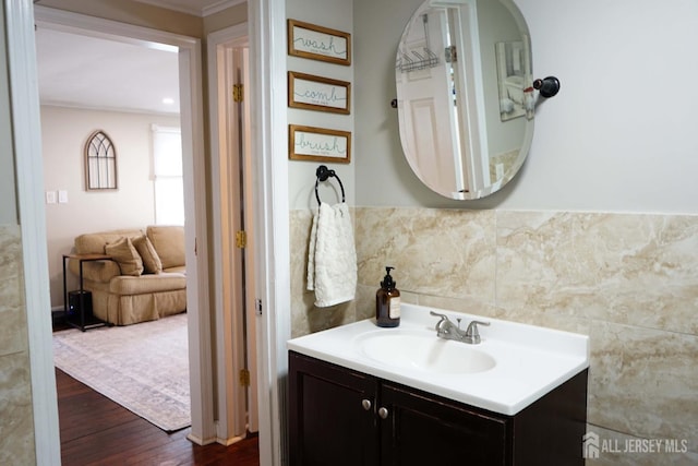 709 Wadsworth Ave, South Plainfield, NJ 07080 - bathroom with vanity, wood finished floors, tile walls, ornamental molding, and wainscoting