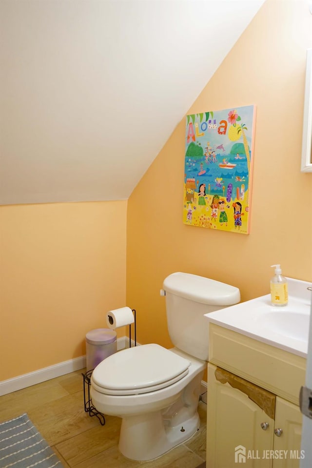 709 Wadsworth Ave, South Plainfield, NJ 07080 - bathroom with vanity, vaulted ceiling, and wood finished floors