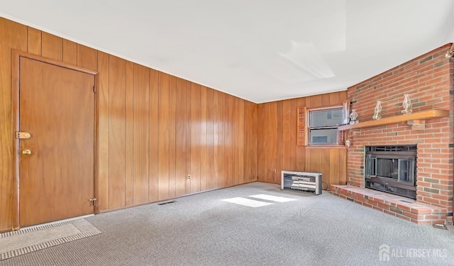 3996 Park Ave, Edison, NJ 08820 - unfurnished living room featuring carpet flooring, a brick fireplace, and wood walls