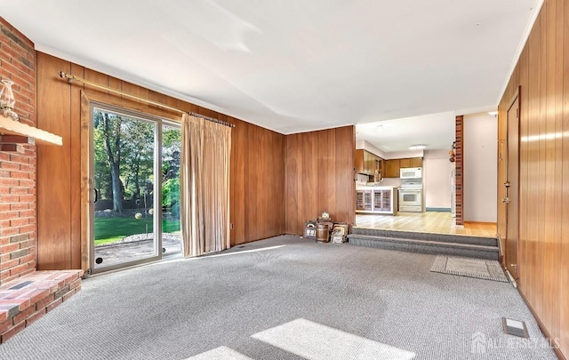 3996 Park Ave, Edison, NJ 08820 - unfurnished living room featuring light colored carpet and wood walls