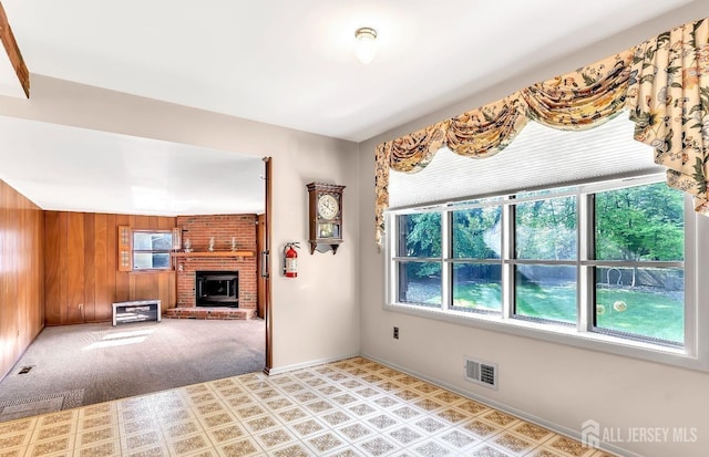 3996 Park Ave, Edison, NJ 08820 - unfurnished living room featuring a fireplace, wood walls, and baseboards