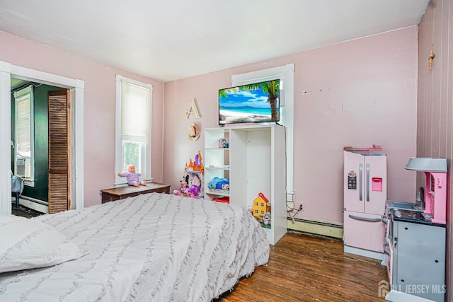 10 W Church St, Jamesburg, NJ 08831 - bedroom with a baseboard heating unit and wood finished floors