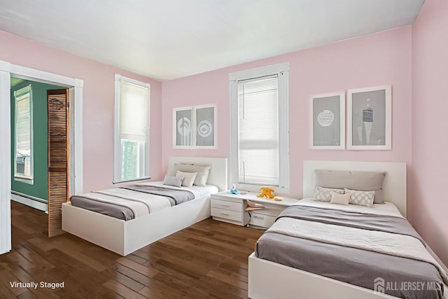 10 W Church St, Jamesburg, NJ 08831 - bedroom with a baseboard heating unit and dark wood-style floors