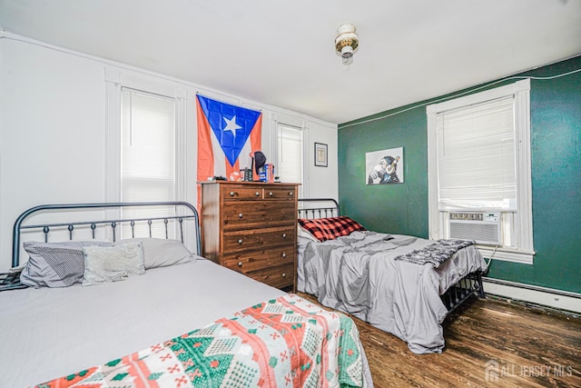 10 W Church St, Jamesburg, NJ 08831 - bedroom featuring baseboard heating, wood finished floors, and cooling unit