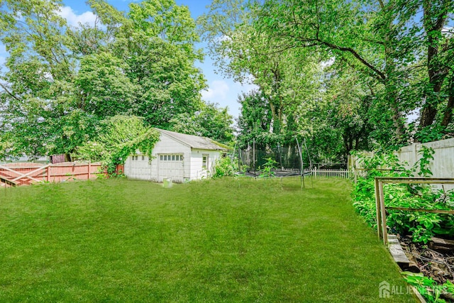 10 W Church St, Jamesburg, NJ 08831 - fenced backyard featuring an outbuilding and a trampoline
