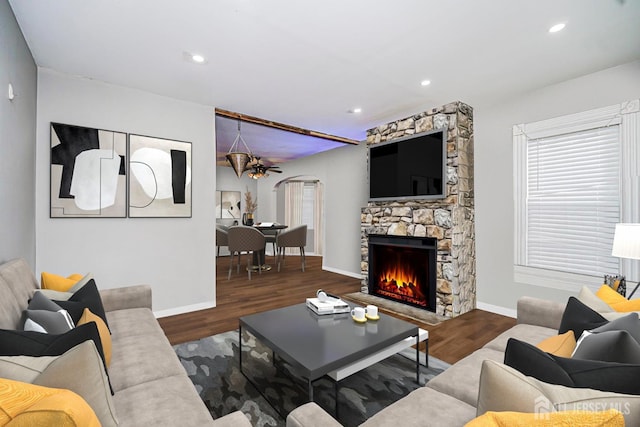 10 W Church St, Jamesburg, NJ 08831 - living area with arched walkways, wood finished floors, a ceiling fan, a stone fireplace, and recessed lighting