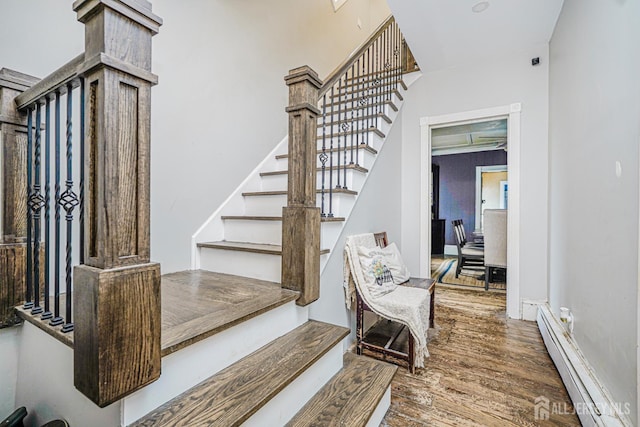 10 W Church St, Jamesburg, NJ 08831 - staircase featuring a baseboard heating unit and wood finished floors