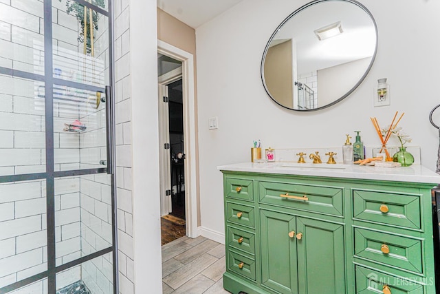 10 W Church St, Jamesburg, NJ 08831 - bathroom featuring vanity, tiled shower, and wood finished floors