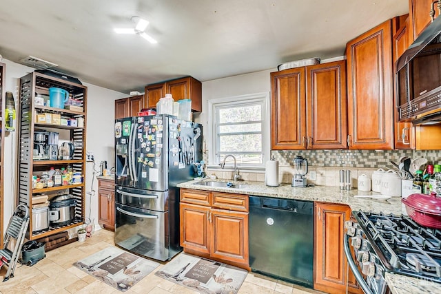 114 Garden Ter, Edison, NJ 08817 - kitchen featuring appliances with stainless steel finishes, brown cabinets, light stone countertops, and tasteful backsplash