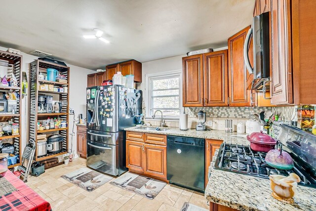 114 Garden Ter, Edison, NJ 08817 - kitchen with appliances with stainless steel finishes, brown cabinets, light stone countertops, and tasteful backsplash