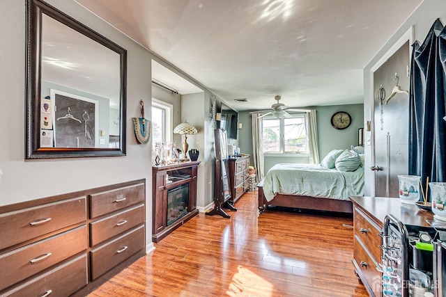 114 Garden Ter, Edison, NJ 08817 - bedroom with light wood-type flooring and a glass covered fireplace