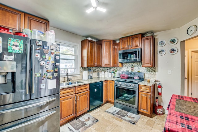 114 Garden Ter, Edison, NJ 08817 - kitchen featuring appliances with stainless steel finishes, decorative backsplash, brown cabinets, and light stone countertops
