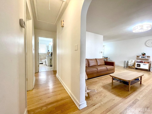 corridor with light hardwood / wood-style flooring