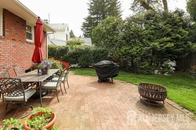 view of patio / terrace featuring a fire pit and grilling area