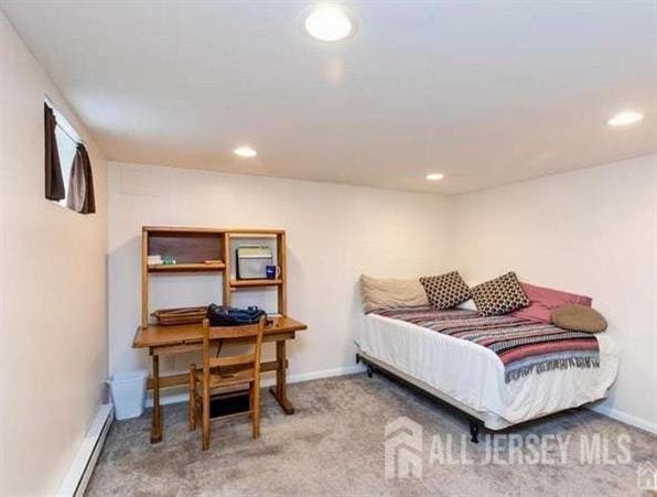 carpeted bedroom featuring a baseboard radiator