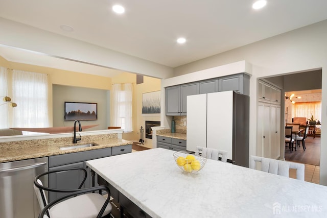 22 Fairway Blvd, Monroe, NJ 08831 - kitchen with gray cabinets, stainless steel dishwasher, freestanding refrigerator, a kitchen bar, and recessed lighting