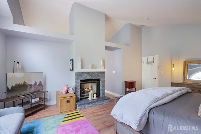 22 Fairway Blvd, Monroe, NJ 08831 - bedroom with high vaulted ceiling, wood finished floors, and a glass covered fireplace