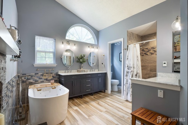 22 Fairway Blvd, Monroe, NJ 08831 - bathroom with a freestanding bath, tiled shower, double vanity, tile walls, and plenty of natural light
