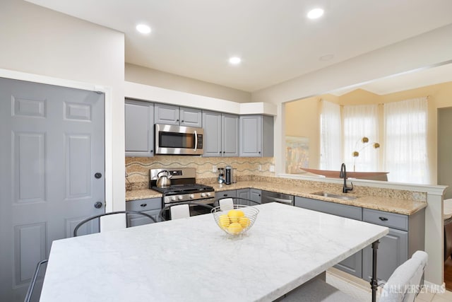 22 Fairway Blvd, Monroe, NJ 08831 - kitchen with appliances with stainless steel finishes, gray cabinets, a peninsula, decorative backsplash, and recessed lighting