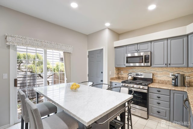 22 Fairway Blvd, Monroe, NJ 08831 - kitchen featuring stainless steel appliances, gray cabinetry, tasteful backsplash, a breakfast bar, and recessed lighting
