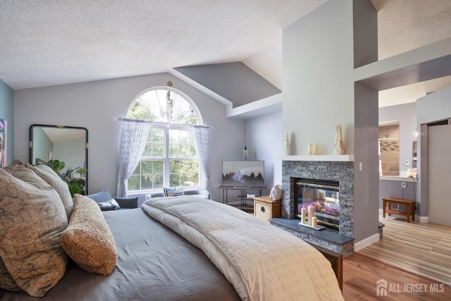 22 Fairway Blvd, Monroe, NJ 08831 - bedroom featuring wood finished floors, vaulted ceiling, and a fireplace