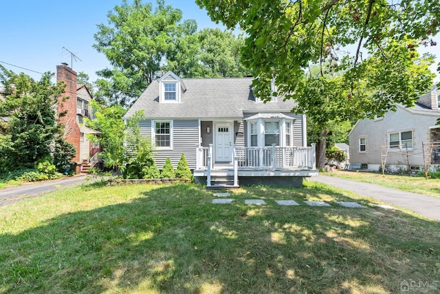 261 New Market Rd, Dunellen, NJ 08812 - new england style home featuring a front lawn and a shingled roof