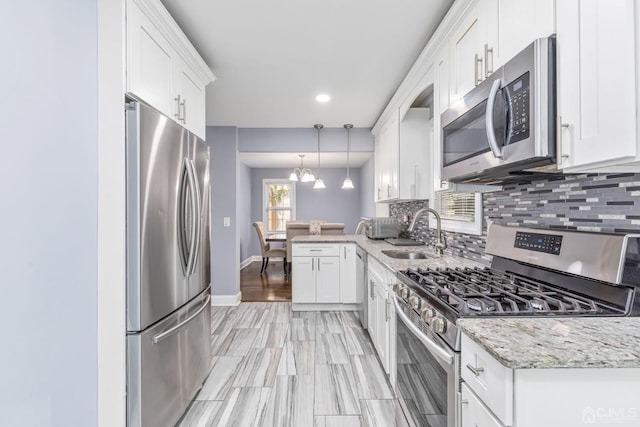 261 New Market Rd, Dunellen, NJ 08812 - kitchen featuring stainless steel appliances, tasteful backsplash, white cabinetry, light stone countertops, and recessed lighting