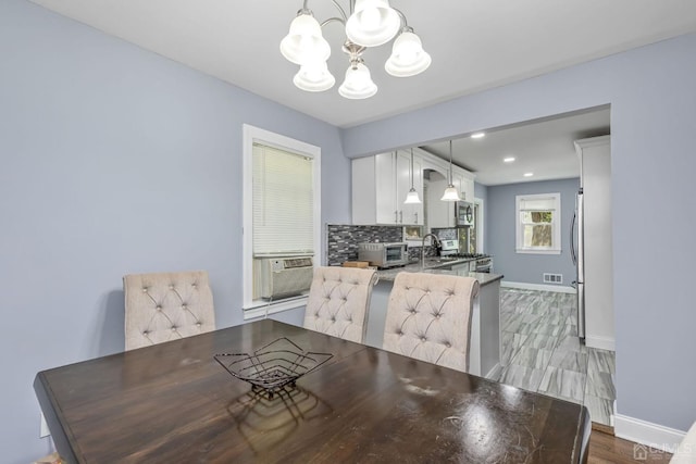 261 New Market Rd, Dunellen, NJ 08812 - dining space with a chandelier, light wood finished floors, and cooling unit