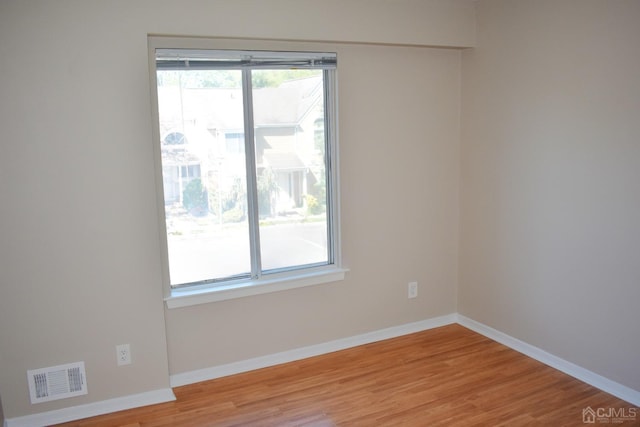 spare room featuring light wood-type flooring