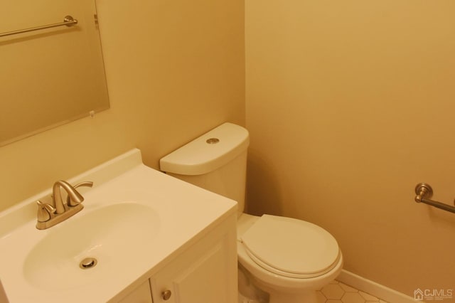 bathroom featuring toilet, vanity, and tile patterned floors