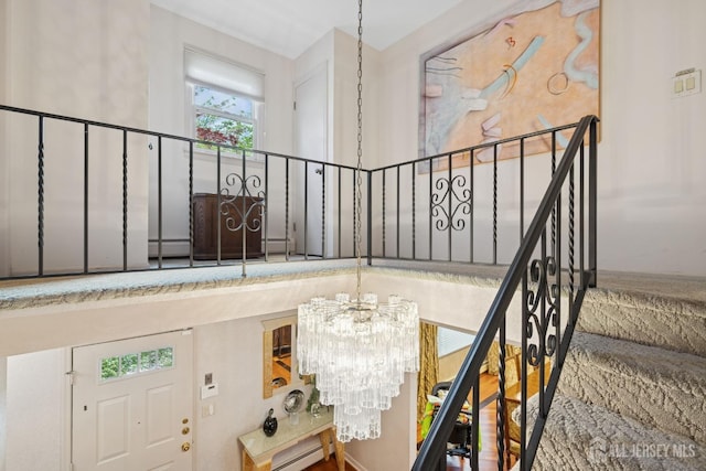 stairs featuring a notable chandelier