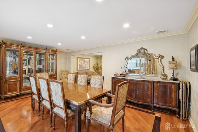 dining room with recessed lighting, visible vents, crown molding, and wood finished floors