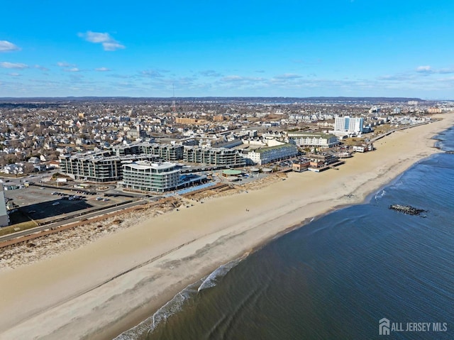 birds eye view of property featuring a water view, a city view, and a view of the beach