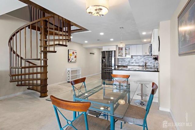 dining room featuring stairs, recessed lighting, baseboards, and arched walkways