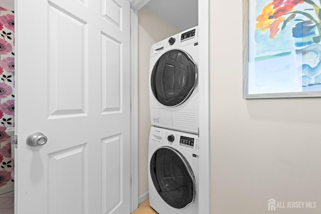 laundry room with stacked washer / dryer