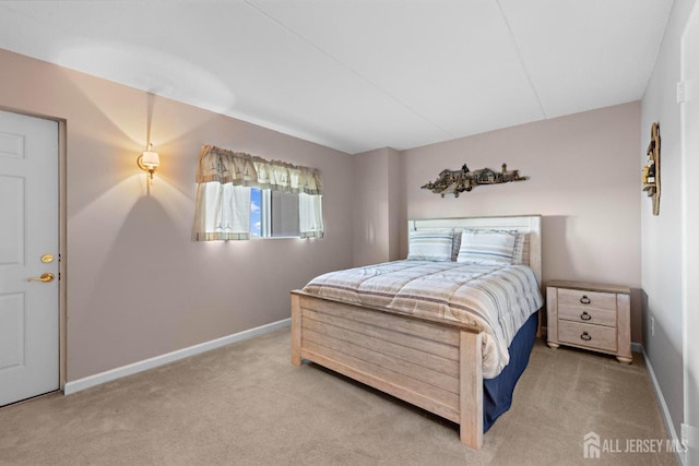 bedroom featuring baseboards and carpet flooring