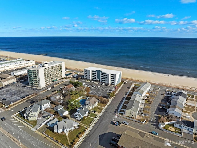 aerial view featuring a water view and a beach view