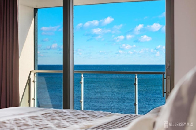 unfurnished bedroom featuring a water view