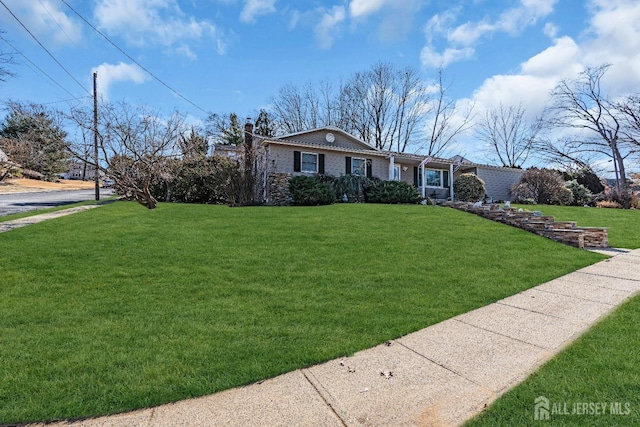 single story home with a front yard, brick siding, and a chimney