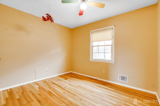 unfurnished room with hardwood / wood-style flooring and ceiling fan