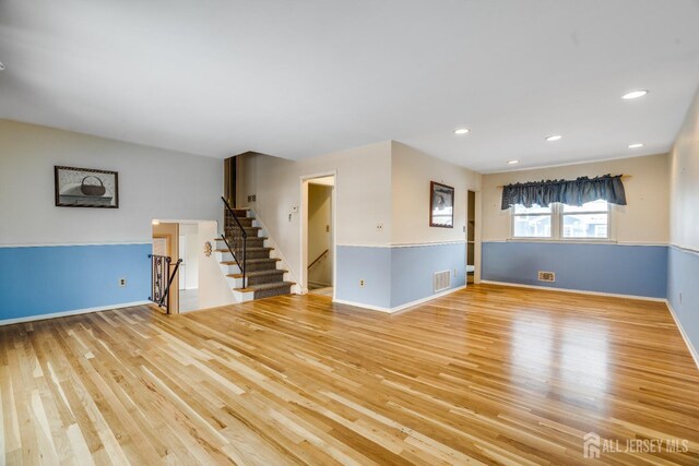 unfurnished room with light wood-type flooring