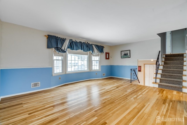 unfurnished room with hardwood / wood-style flooring