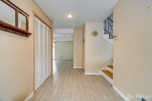 hallway with light hardwood / wood-style floors