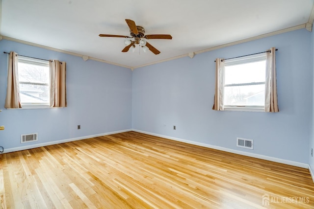 empty room with light hardwood / wood-style flooring, ornamental molding, and ceiling fan