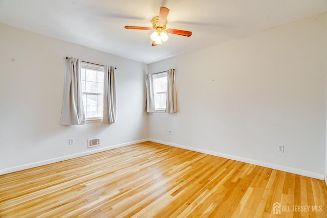 unfurnished room featuring ceiling fan and light wood-type flooring