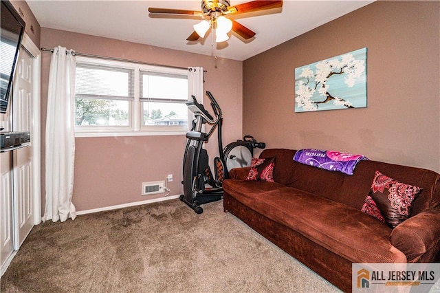 workout area featuring ceiling fan and carpet