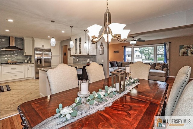 dining room featuring ceiling fan with notable chandelier