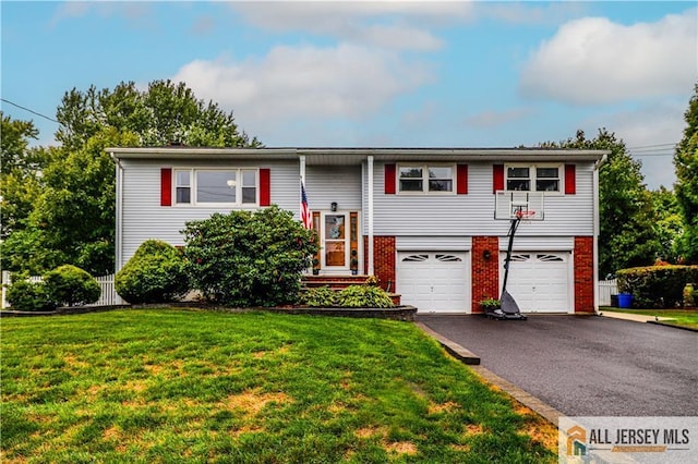 bi-level home with a garage and a front yard